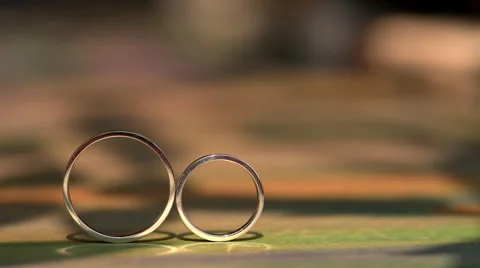 Wedding ring roll and fall on each other Video stock 65421175