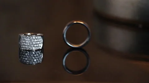 Wedding ring rolling into other wedding ring. Stock Footage