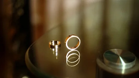 Wedding ring rolls and falls Stock Footage 73109221