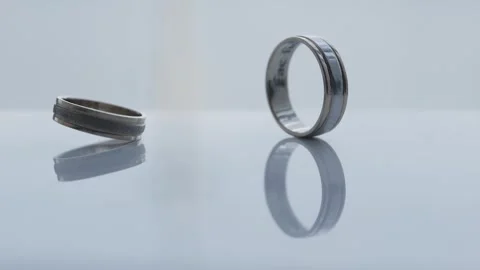 The wedding ring spins around its axis and falls Stock Footage 306148595