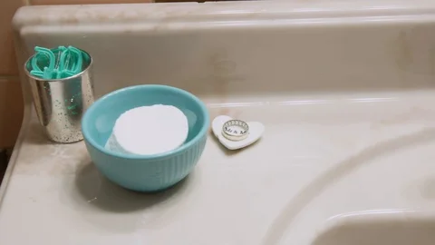 Wedding Ring stored safely on cute placeholder on bathroom sink, 60fps Stock Footage 125499477