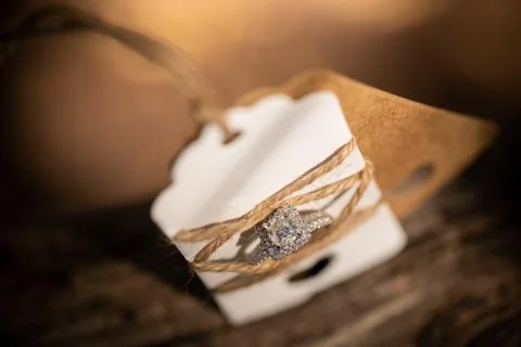 Wedding ring tied with string with brown background Foto stock