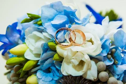 Wedding ring. Two gold romantic rings of the bride and groom are on a bouquet Stock Photos
