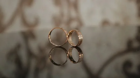 Wedding ring. The wedding ring rolls onto another and hits it. Video stock 132028746