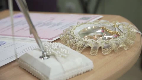 Wedding rings and a document at the wedding Stock Footage 140507257