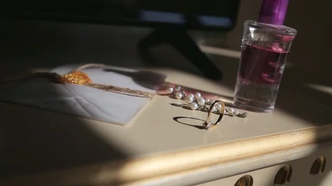 Wedding rings and perfumes on the table before the wedding day Видео 127570586