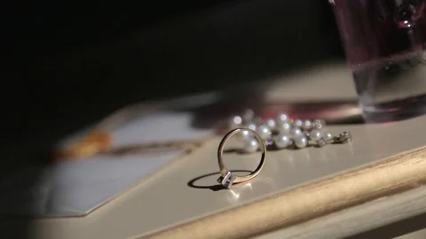 Wedding rings and perfumes on the table before the wedding day Видео 127570638