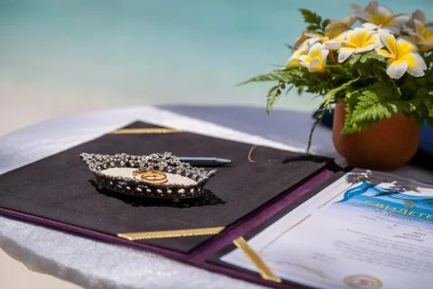 Wedding rings and wedding certificate on a tropical wedding on the background Stock Photos