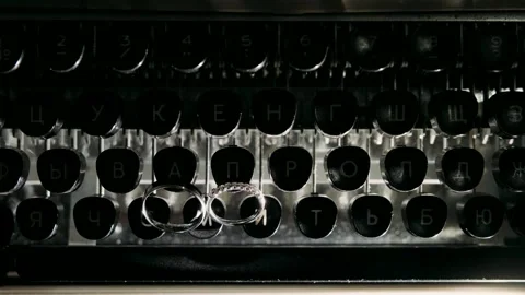 Wedding rings are lying on a typewriter Stock Footage 318162775