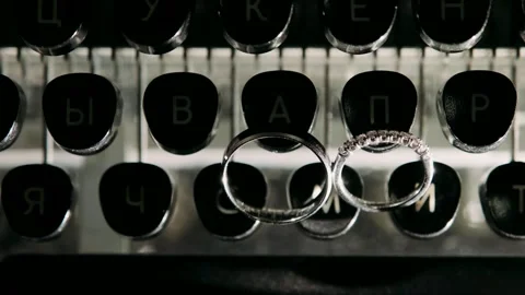 Wedding rings are lying on a typewriter Stock Footage 318162882