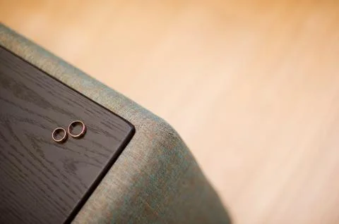 Wedding rings on the armrest of the sofa Stock Photos