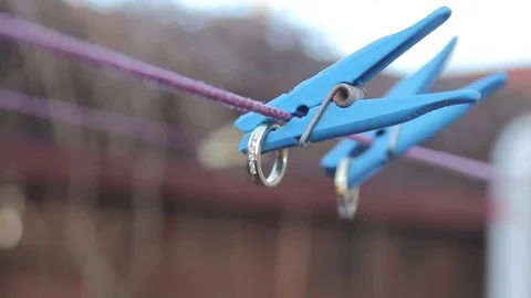 Wedding rings attached to a clothespin Stock Footage 73780095