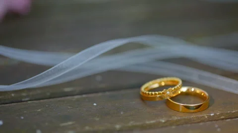 Wedding rings in a beam of light Stock Footage 67658565