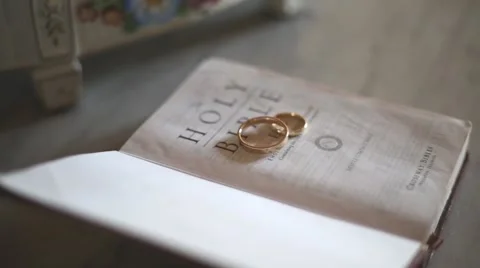 Wedding rings on bible Stock Footage 63329894