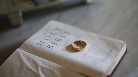 Wedding rings on bible Stock Footage 63329950