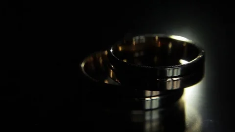 Wedding rings black background shining with light jewelry close up macro Stock Footage 70997125