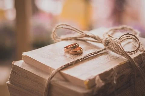 Wedding rings on book background rustic Stock Photos