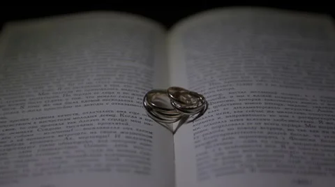Wedding rings on a book Stock Footage 44208492