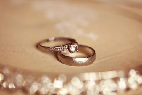Wedding rings on a brown background Stock Photos
