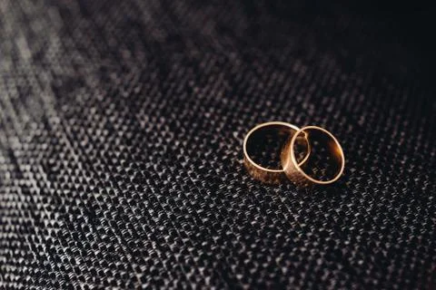Wedding rings on brown background Stock Photos