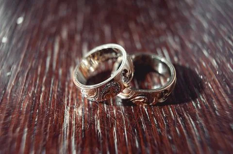 Wedding rings with carving pattern on the table Stock Photos