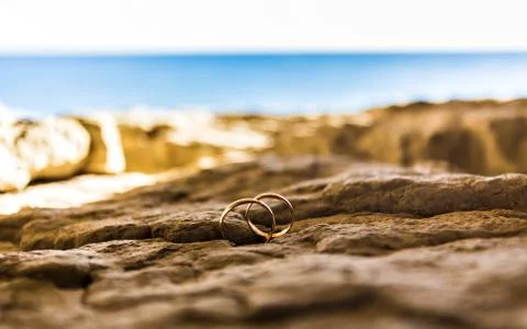 Wedding rings on a coast Stock Illustration