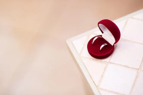 Wedding rings on the edge of a table Stock Photos