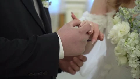 Wedding rings exchanged, symbolizing love and commitment between bride and groom Stockbeeldmateriaal 277649171