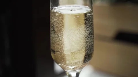 Wedding rings falling into champagne Stock Footage 138943960