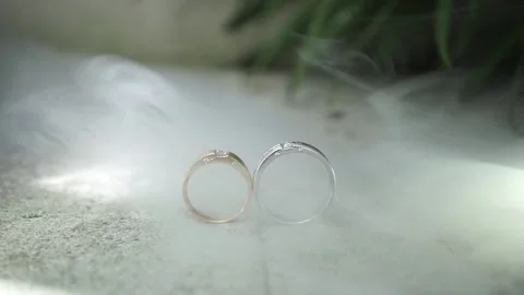 Wedding rings on a floor with smoke Stock Footage 140239656