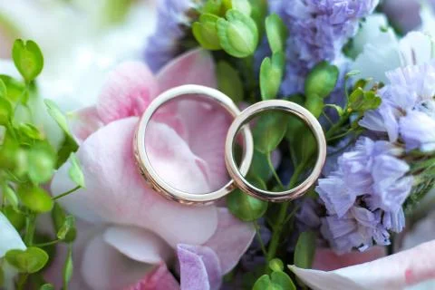 Wedding rings on flowers Photos