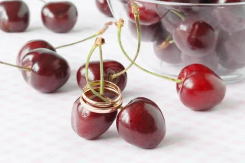Wedding rings on fresh cherry Stock Photos