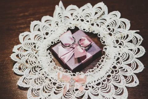 Wedding rings on gift with bow 写真素材