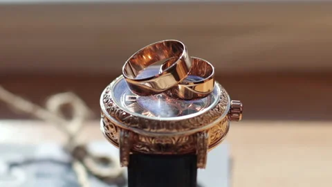 Wedding rings on a gold watch. Stock Footage 167606187