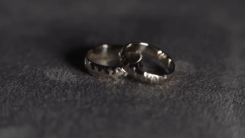 Wedding rings on gray background Stock Footage 105259484