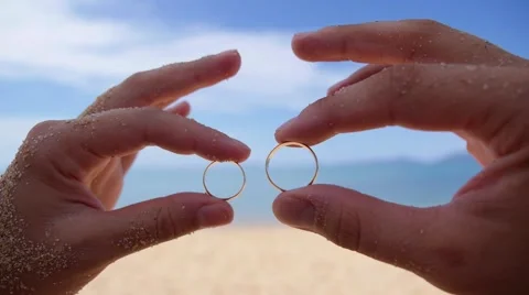 Wedding Rings in Hands on Beach against Sea. Stock Footage 44406168
