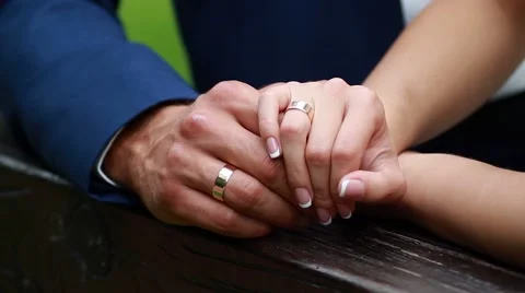 Wedding rings in the hands of the bride and groom Stock Footage 52512559
