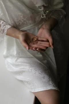 Wedding rings in the hands of the bride Stock Photos