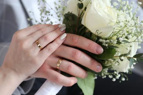 Wedding rings on hands Stock Photos