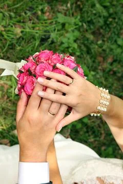 Wedding rings on hands Stock Photos