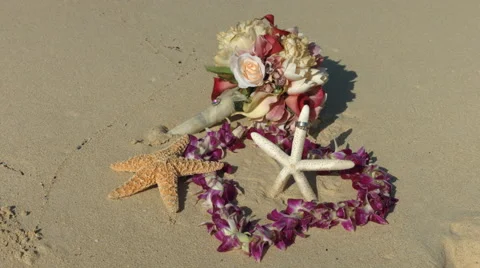 Wedding rings, lei and startfish beach love concept Stock Footage 57707520