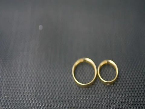 Wedding rings lie on a black background Video stock 80493354