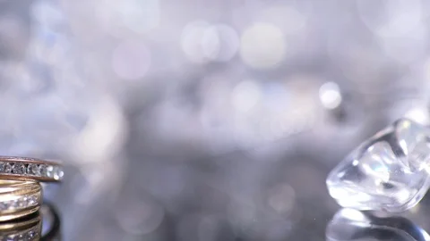 Wedding Rings Lie On Shiny Table And Silver Background, Close-Up Stock-Footage 128827336