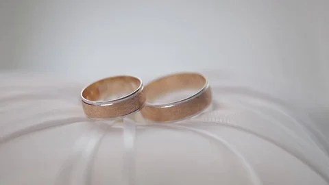 Wedding rings on a light background with reflections Stock Footage 73484289