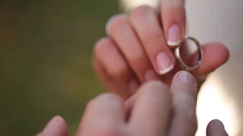 Wedding Rings macro closeup Putting the ring on your finger white gold diamon Stock Footage 93714518