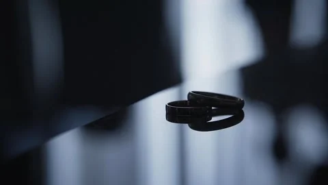 Wedding rings on a mirror in backlight Stock Footage 306148770