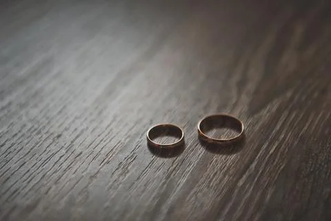 Wedding rings on oak table 2172. Stock Photos