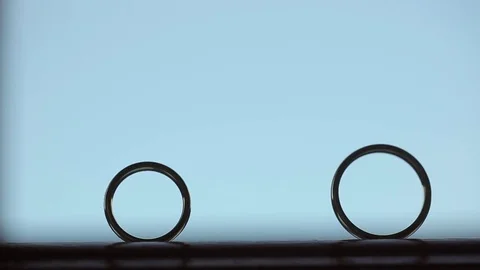 Wedding rings - one rolls to another Stock Footage 73145596