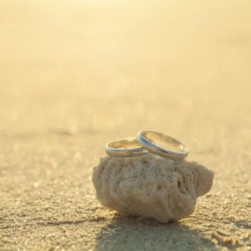 Wedding rings put on the beachside. Stock Photos