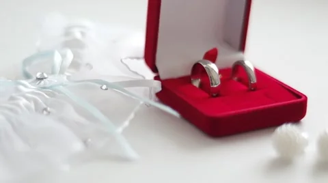 Wedding rings in a red box with earrings and garter 動画素材 64641385